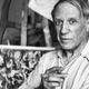 Pablo Picasso smoking a cigarette in his Paris studio
